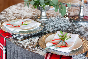 Silver tablecloth on the table. The plate is decorated with flowers