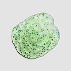 Green Gel exfoliating mask peeling with natural particles smear on gray background