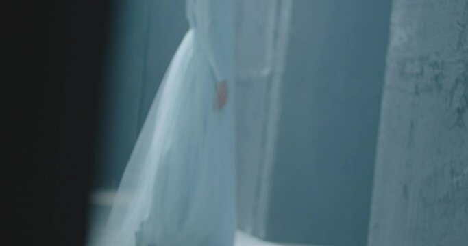 Side or back view of girl standing inside dark maze . Footage of mystic video of bride in labyrinth . Vision of mystical dream . Shot on ARRI ALEXA Cinema Camera in slow motion .