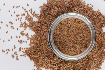 top view of linseed on white background, close up of a Brown flax seeds in a bowl
