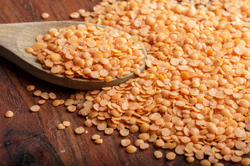Split red lentils in the wooden spoon 