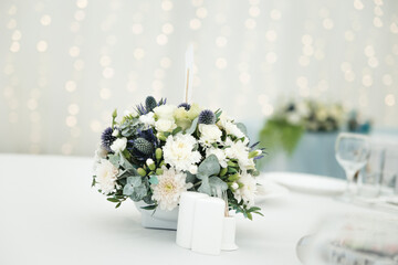 bouquet of white flowers on the wedding table 