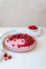 Fototapeta na wymiar Homemade cheesecake slice with fresh raspberries and mint leaves on white plate on the table. Healthy organic summer dessert