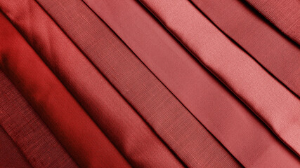 close up multi red tone of silk fabric samples in catalog. interior drapery or upholstery material palette background for interior concept. vintage drapery background.
