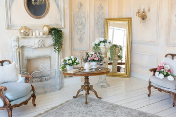 luluxury rich sitting room interior in beige pastel color with antique expensive furniture in baroque style. walls decorated with stucco and frescoes