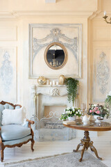 luluxury rich sitting room interior in beige pastel color with antique expensive furniture in baroque style. walls decorated with stucco and frescoes