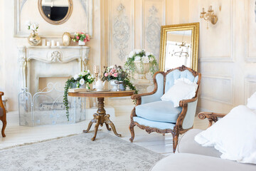 Fototapeta na wymiar luluxury rich sitting room interior in beige pastel color with antique expensive furniture in baroque style. walls decorated with stucco and frescoes