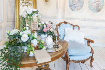 luluxury rich sitting room interior in beige pastel color with antique expensive furniture in baroque style. walls decorated with stucco and frescoes