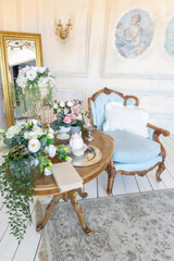luluxury rich sitting room interior in beige pastel color with antique expensive furniture in baroque style. walls decorated with stucco and frescoes