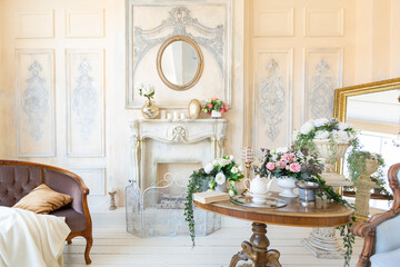 luluxury rich sitting room interior in beige pastel color with antique expensive furniture in baroque style. walls decorated with stucco and frescoes