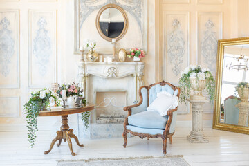 luluxury rich sitting room interior in beige pastel color with antique expensive furniture in baroque style. walls decorated with stucco and frescoes