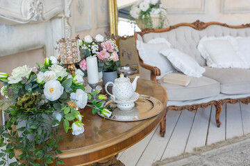 luluxury rich sitting room interior in beige pastel color with antique expensive furniture in baroque style. walls decorated with stucco and frescoes