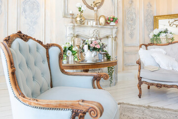 luluxury rich sitting room interior in beige pastel color with antique expensive furniture in...