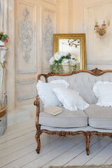 luluxury rich sitting room interior in beige pastel color with antique expensive furniture in baroque style. walls decorated with stucco and frescoes