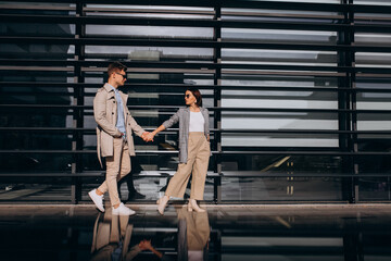 Young couple standing by the building
