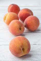 A group of peaches over wooden table