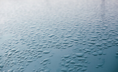 Abstract background ornament with water drops. Raindrops on a polished surface.