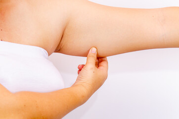 Beautiful fat woman with tape measure She uses her hand to squeeze the excess fat that is isolated on a white background. She wants to lose weight, the concept of surgery and break down fat under the