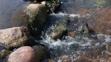 Running water of the stream between the rocks