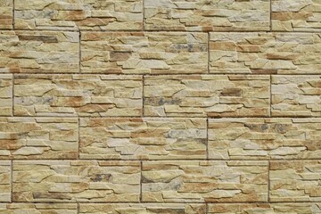Stoneware cladding wall with stone effect. Colors are flaxen yellow, beige and brown.   Background and texture.	
