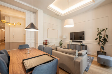 living room with tv and armchairs in a beautiful apartment for vacation rental recently renovated with all the luxury of interior decoration details