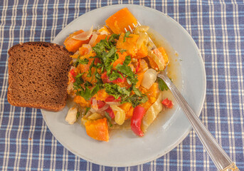 Plate with vegetable ragout and chicken. Flat lay