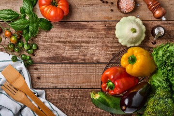 Assortment of fresh fruits and organic multicolored rainbow vegetables on old wooden rustic background. Food cooking background and mock up.