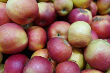 Fresh ripe red apples as background, sweet apples in box in supermarket