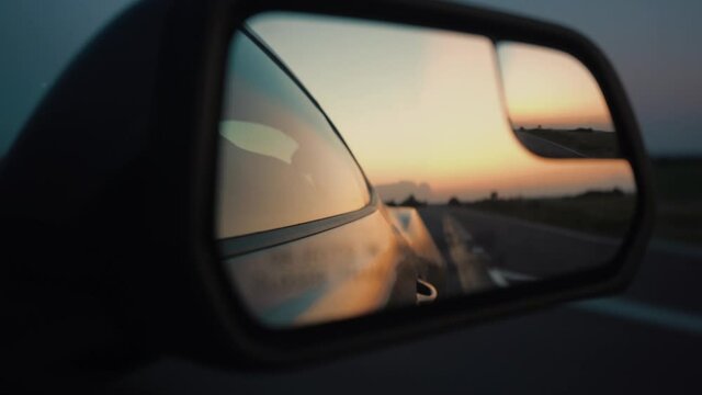 Reflection of the sunset in the car mirror