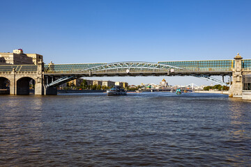 Beautiful city landscape, view of the Moscow River and the Pushkin (Andreevsky) pedestrian Bridge on a sunny summer evening - Moscow, Russia, July 2021