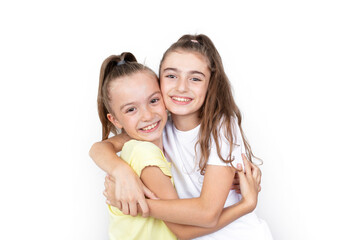 Two happy children hugging on white background