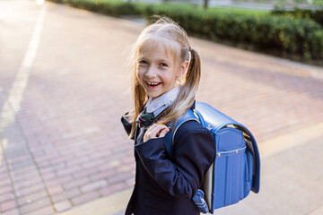 Back to school. Little girl from elementary school outdoor. Kid going learn new things 1th september