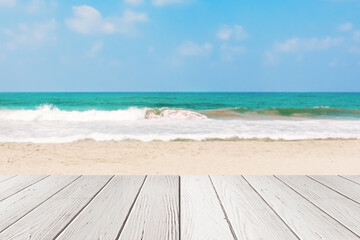 Fototapeta premium White Plank Wooden Table in front of Sea or Ocean Sand Beach Background . 3d Rendering