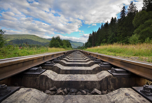 Railroad Against Mountains And Beautiful Sky, Near Forest.