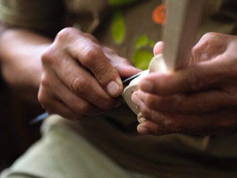 Luthier violinmaker scultping a classic violin curl - Powered by Adobe