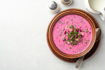 Cold borscht or Holodnik or Svekolnik, traditional summer beet soup in ceramic bowl on concrete background