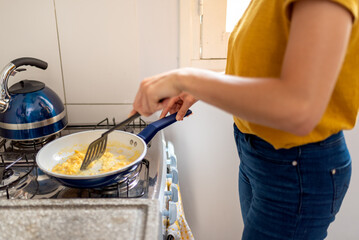 Young latin woman making healthy breakfast with fruits at home.