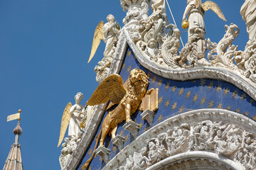 Fototapeta na wymiar Gold Lion on the facade of the St. Mark's Basilica, Venice, Italy