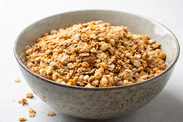 Granola cereal in bowl on concrete background