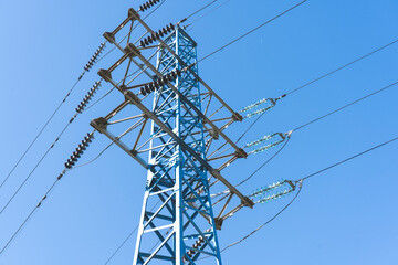 a line of high-voltage wires on a blue sky background