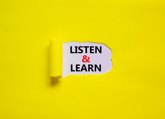 Listen and learn symbol. Words 'Listen and learn' appearing behind torn yellow paper. Beautiful...