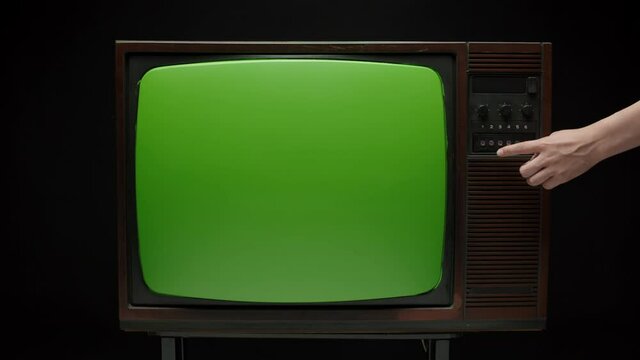 Old retro television with antenna on grey background. Broken old-fashioned TV screen with ripples on table, bad signal reception, cinematography concept.