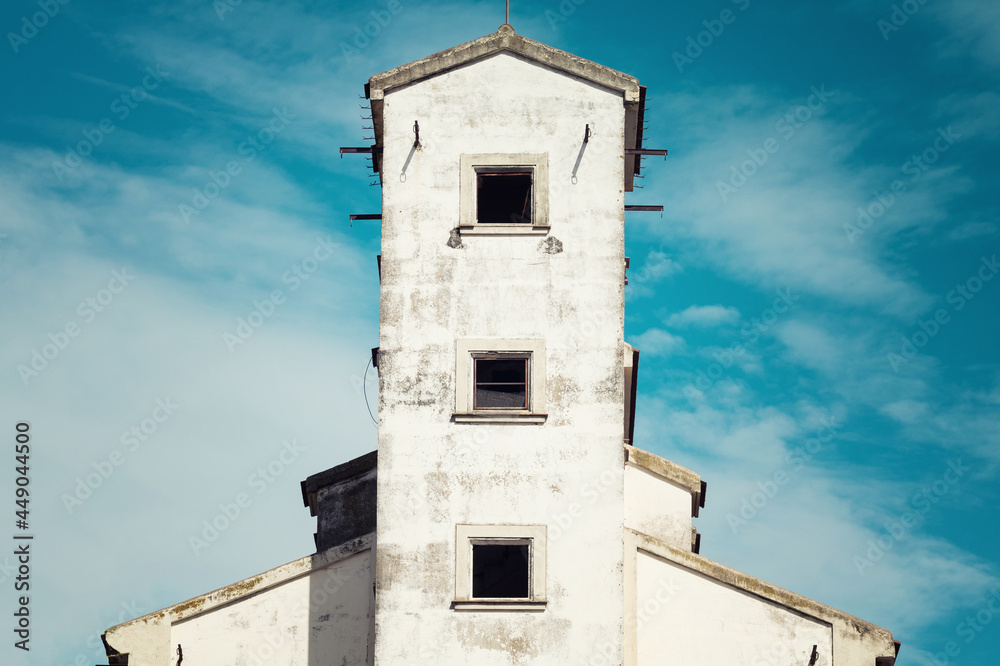 Poster Abandoned factory.  Close up of main factory building in a state of disrepair.