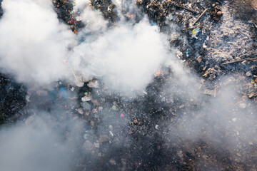 Garbage and fire burn in landfill. Also call trash, waste, rubbish. Destruction with combustion, heat, flame. Occurs smoke, toxic cause of air pollution, environmental damage and global warming. - obrazy, fototapety, plakaty