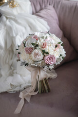 Stylish bridal bouquet of preserved flowers. Wedding bouquet of white and pink roses. Close up of wedding bouquet.