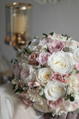 Stylish bridal bouquet of preserved flowers. Wedding bouquet of white and pink roses. Close up of wedding bouquet.