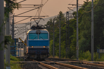 Trains and whistle stop Olesko in central Bohemia in sunset orange evening