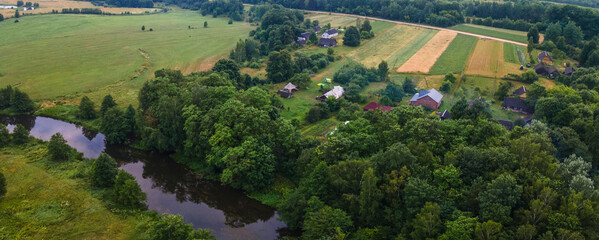 Aerial landscape of winding river in green field, top view of beautiful nature background from drone, seasonal summer landscape with copy space.