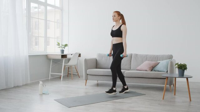 Fitness Woman Doing Step Lunges Holding Dumbbells Exercising At Home