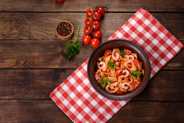 Fettuccine pasta with shrimp, cherry tomatoes, sauce, spices and herbs